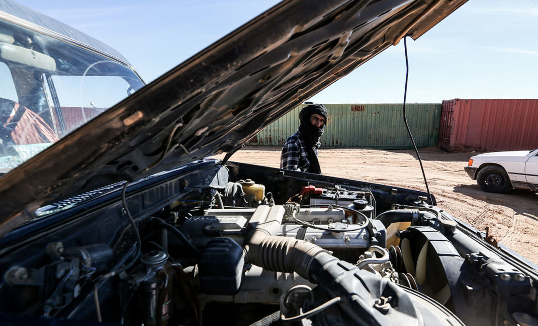 A man near his broken car in Rabouni