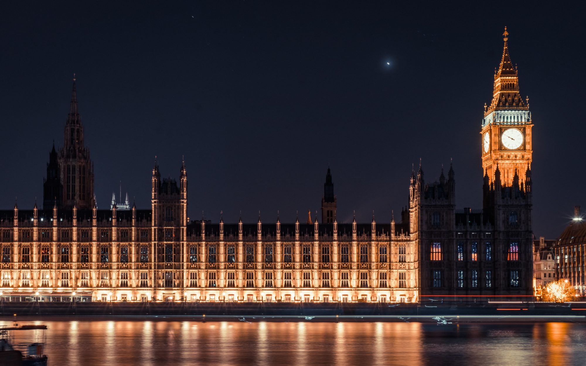 Houses of Parliament lit up at night - Photo by Samuel Zeller on Unsplash