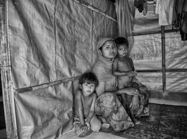 Farjina with her two sons, in their makeshift hut in the Balukhali Refugee Camp by Francesc Galban