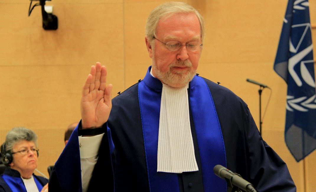 Judge Howard Morrison stands with his right hand raised as he is sworn in at the ICC