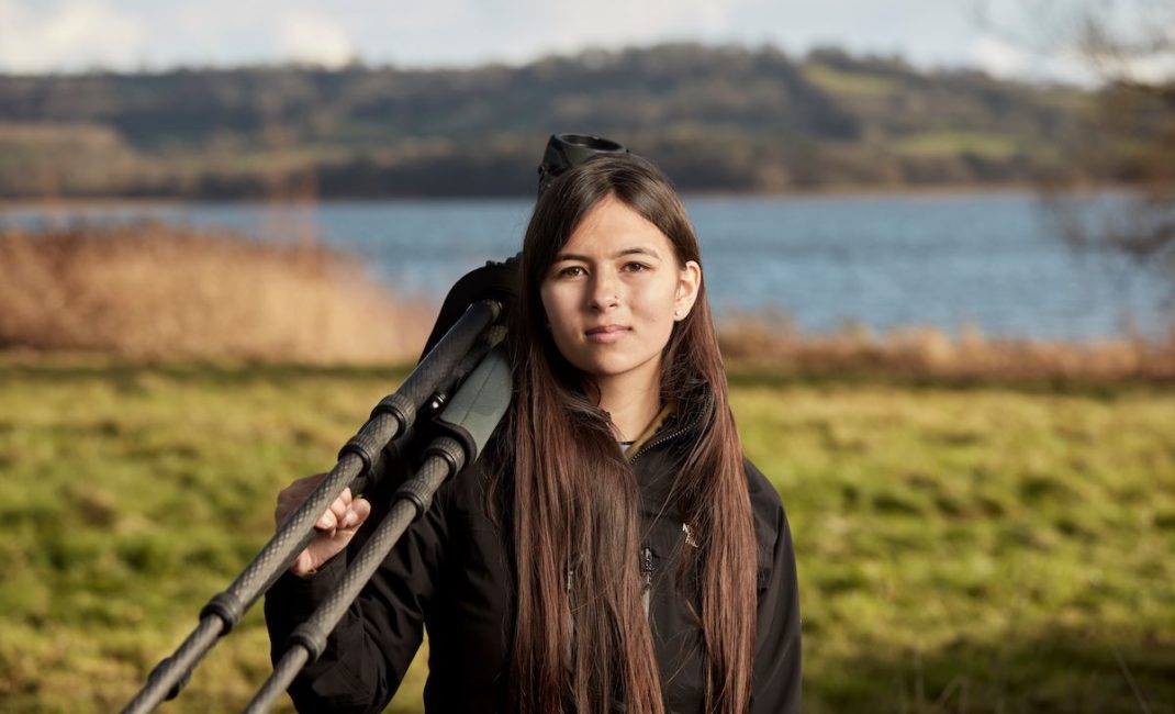 Mya-Rose Craig holds binoculars used for birdwatching. 