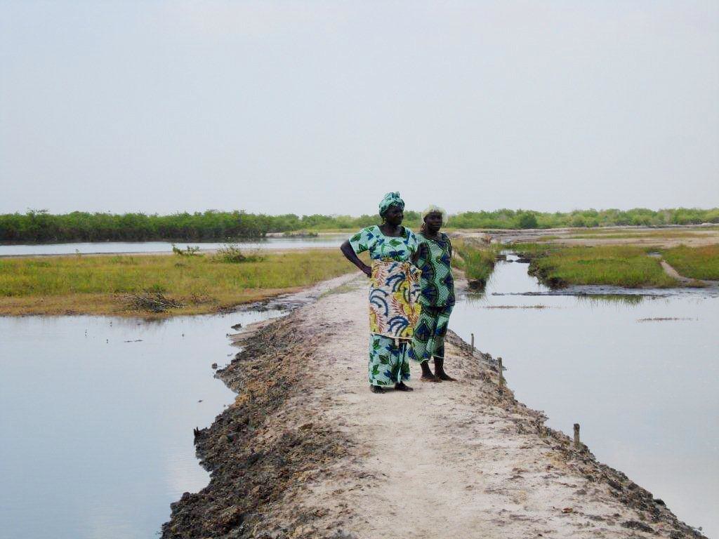 Two women in Senegal look out over the water