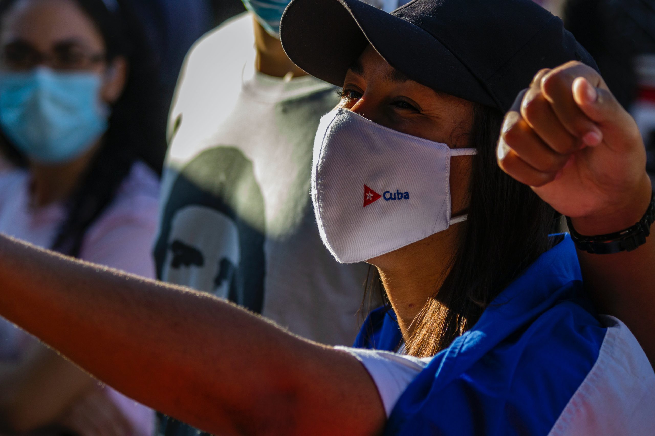 Woman wearing a mask with 'Cuba' embroidered on it