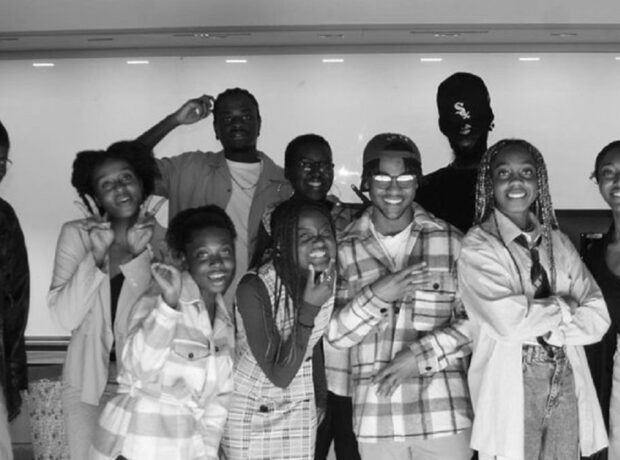 black and white picture, black students of the Reclaim Collective laughing, looking happily into the camera