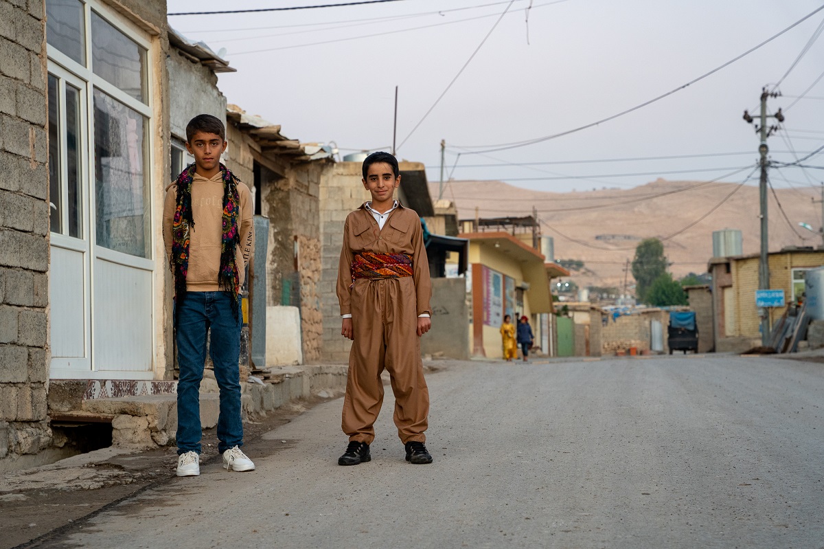 Boys from the Makhmour camp pause in the street for a photograph.