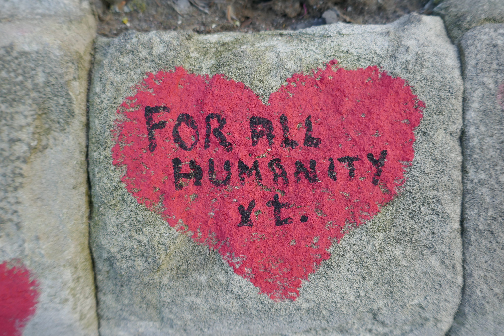 Red heart from the Covid-19 memorial wall which reads "For all humanity xx"