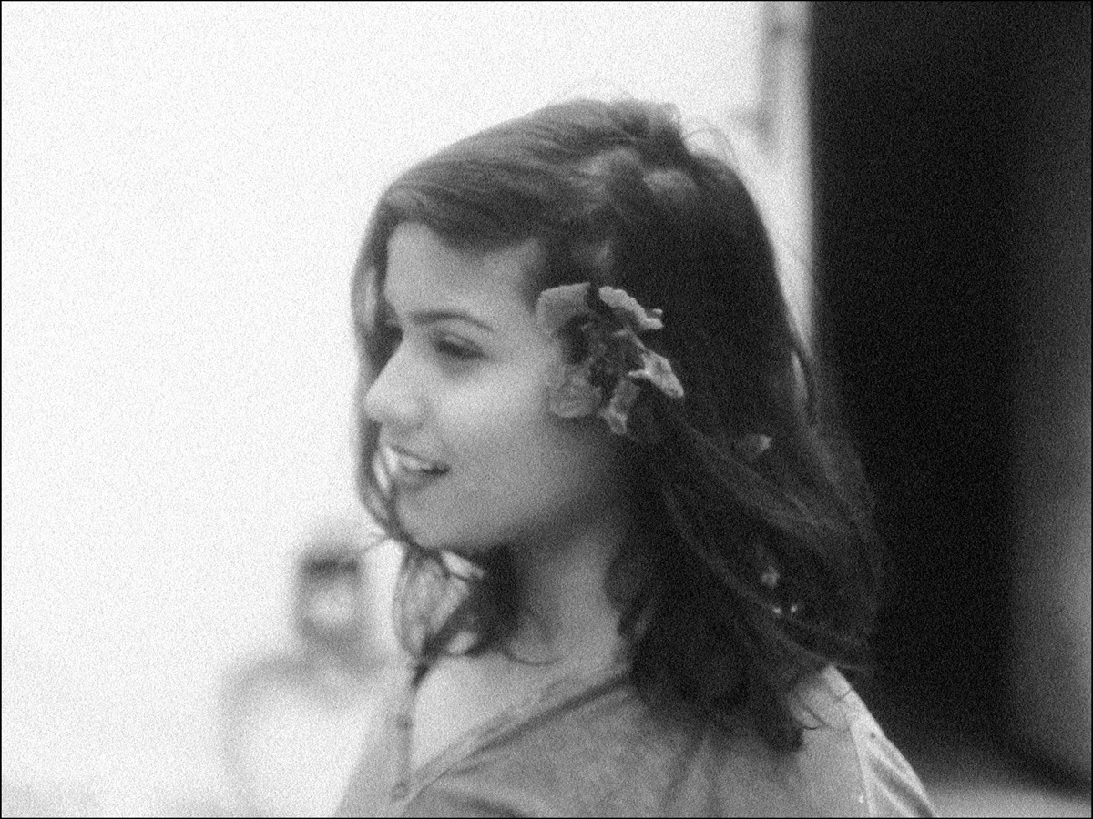 Black and white photograph showing a young lady from the side with a flower in her hair - for human rights film festival story