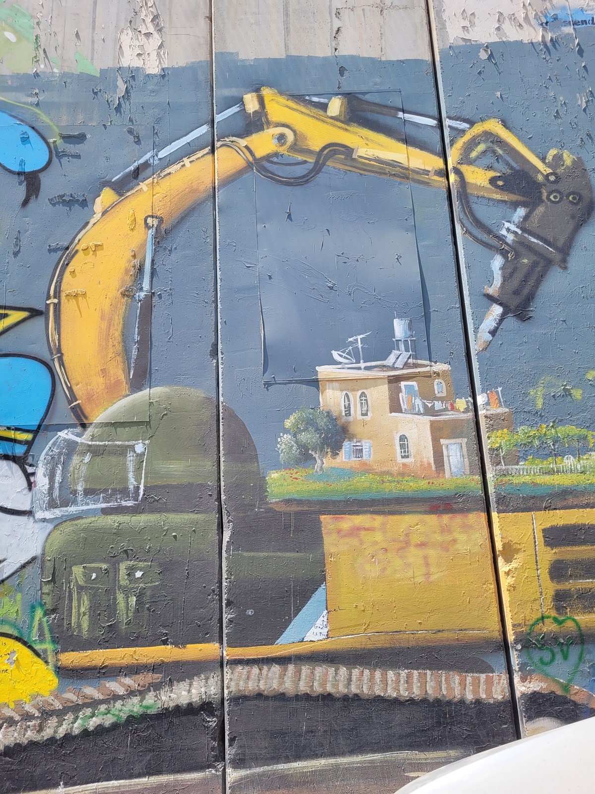 Graffiti mural of the crane Israel uses to demolish Palestinian houses, on a section of the separation wall, Bethlehem
