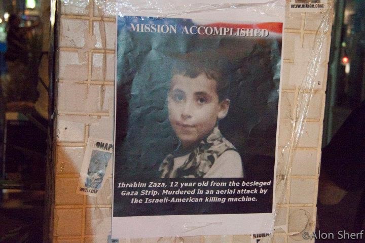 A poster of Ibrahim, Mohammed's cousin which reads: "Mission Accomplished" across an American flag. The following caption is under a photo of Ibrahim "Ibrahim Zaza, 12 year old from the besieged Gaza Strip. Murdered in an aerial attack by the Israeli-American killing machine.