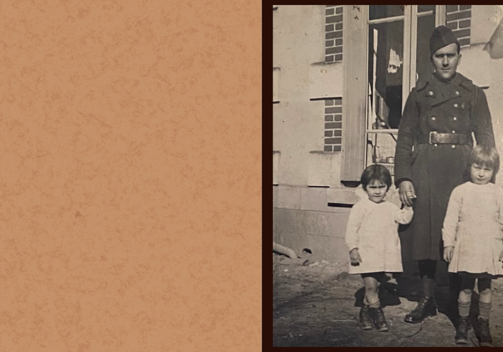 Photo of picture of a soldier in uniform. He is standing behind two little girls, wearing similar dresses and some high socks.