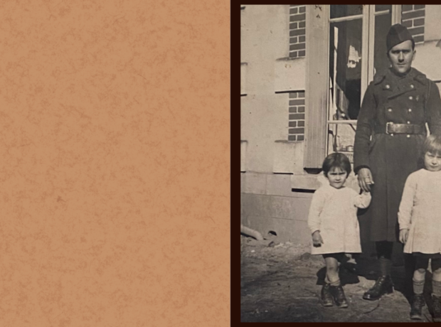 Photo of picture of a soldier in uniform. He is standing behind two little girls, wearing similar dresses and some high socks.