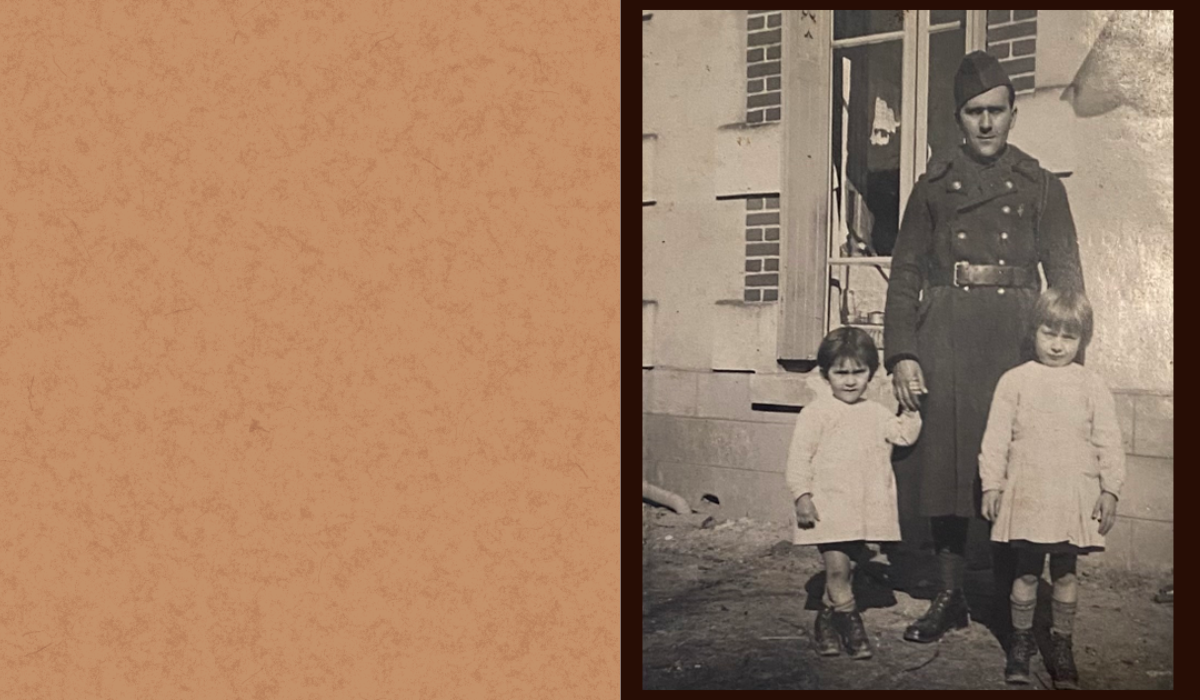 Photo of picture of a soldier in uniform. He is standing behind two little girls, wearing similar dresses and some high socks.