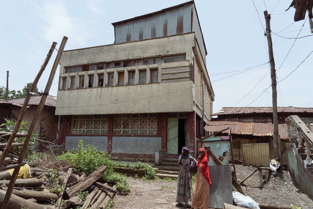 Photograph by Jaclynn Ashly showing  Muslim homes in the Piassa neighborhood with broken windows